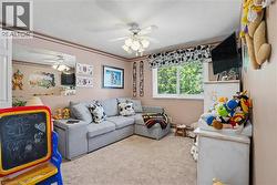 Carpeted room with a ceiling fan light fixture - 