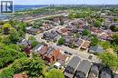 Aerial perspective showcasing a residential area with diverse architectural styles, mature trees, and paved streets - 193 Locke Street N, Hamilton, ON 