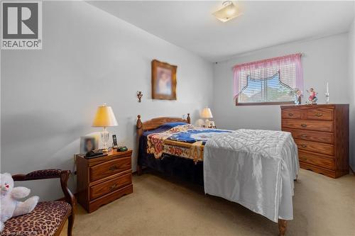 Bedroom featuring light-colored walls and soft carpet flooring. - 202 Ray Street N, Hamilton, ON - Indoor Photo Showing Bedroom