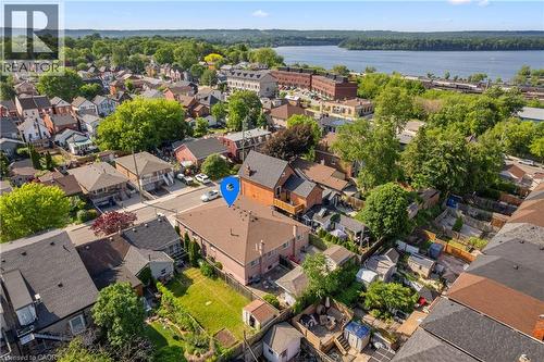 Two-story residential property with a light-colored exterior and a brown shingle roof. - 202 Ray Street N, Hamilton, ON - Outdoor With Body Of Water With View