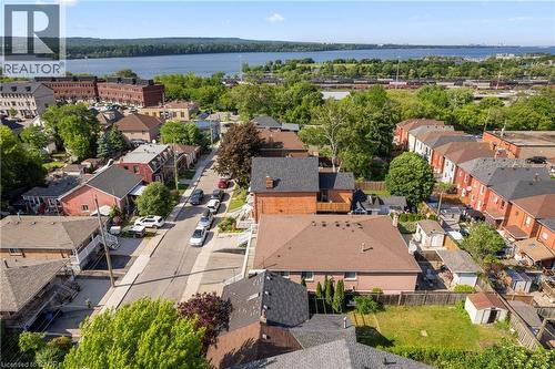 Residential neighborhood setting with a prominent body of water in the background. - 202 Ray Street N, Hamilton, ON - Outdoor With Body Of Water With View