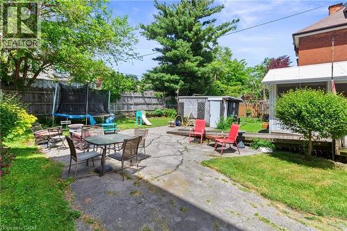 Expansive backyard featuring a combination of grassy areas and a concrete patio. - 193 Locke Street N, Hamilton, ON - Outdoor With Deck Patio Veranda With Backyard