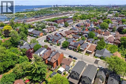 Aerial perspective showcasing a residential area with diverse architectural styles, mature trees, and paved streets - 193 Locke Street N, Hamilton, ON - Outdoor With View