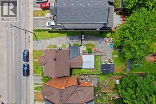 Property featuring a brown shingle roof, paved driveway, and established green spaces - 193 Locke Street N, Hamilton, ON - Outdoor