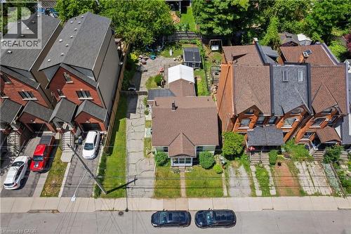Aerial perspective showcasing a detached residence with a prominent gabled roofline and light-colored siding. - 193 Locke Street N, Hamilton, ON - Outdoor