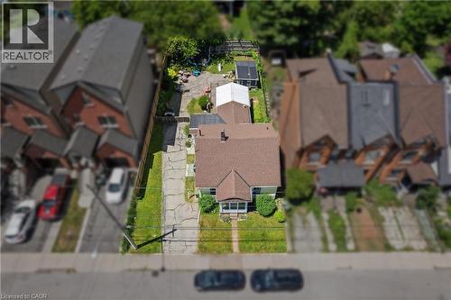 Aerial perspective showcasing a detached residence with a prominent gabled roofline and light-colored siding. - 193 Locke Street N, Hamilton, ON - Outdoor With View