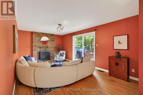 Cozy gathering space with fireplace focal point - 1681 Amberdale Crescent, Ottawa, ON 