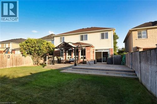Spacious backyard featuring a multi-level wood deck with integrated steps, a mature tree, and a fenced perimeter - 188 Hunter Way, Brantford, ON - Outdoor