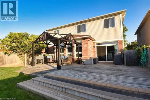 Multi-level wood deck featuring a built-in pergola and brick exterior accents - 188 Hunter Way, Brantford, ON - Outdoor