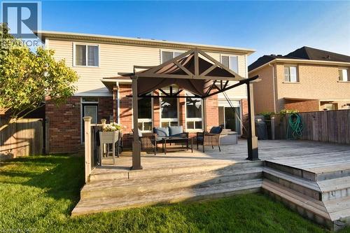 Multi-level wood deck featuring a covered patio area with a dark metal gazebo frame - 188 Hunter Way, Brantford, ON - Outdoor