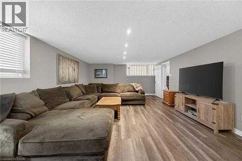 Open concept living area featuring recessed lighting, wood-finish flooring, and neutral wall tones - 25 Inverness Avenue, Hamilton, ON 