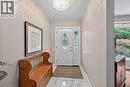 Inviting entryway with a white front door featuring decorative oval and sidelight glass - 25 Inverness Avenue, Hamilton, ON 
