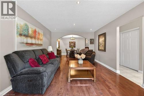Open-concept living space featuring wood-finish flooring and recessed lighting - 25 Inverness Avenue, Hamilton, ON 