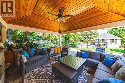 Covered patio with a natural wood-finish vaulted ceiling and recessed lighting - 33 Golfview Crescent, Dundas, ON 