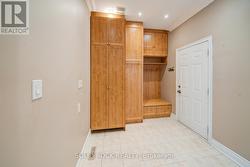 Mudroom with matching cabinetry and hidden laundry - 