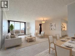Open-concept living area featuring a full-width balcony, carpeted flooring, wainscoting, crown molding, and built-in shelving with cabinetry - 