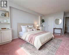 Spacious room featuring light-colored walls and plush carpeting - 