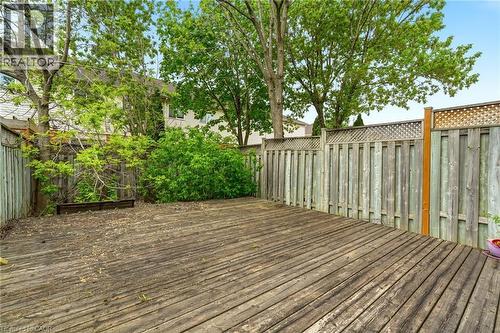 Expansive wood deck with plank construction, surrounded by a wood privacy fence featuring lattice accents - 4413 Peter Drive, Burlington, ON 