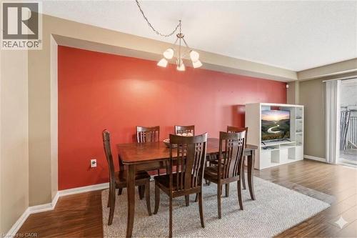 Wood-finish flooring throughout, complemented by a light area rug - 4413 Peter Drive, Burlington, ON 