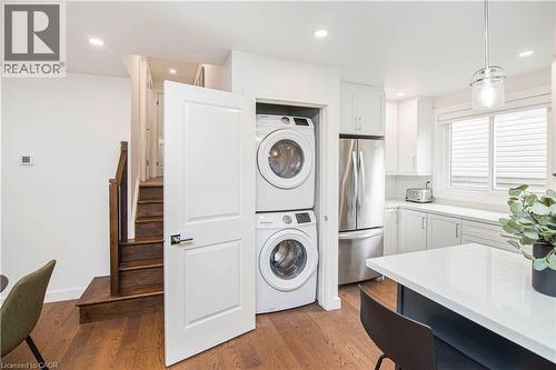Efficiently designed laundry closet with stacked appliances - 39 Forestgate Drive, Hamilton, ON 
