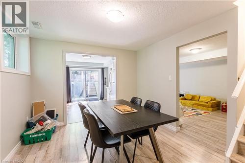 Room featuring wood-finish flooring, recessed lighting, and a white trim baseboard - 907 Doon Village Road, Kitchener, ON 