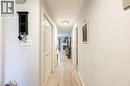 Hallway featuring light wood-finish flooring and neutral wall tones - 907 Doon Village Road, Kitchener, ON 