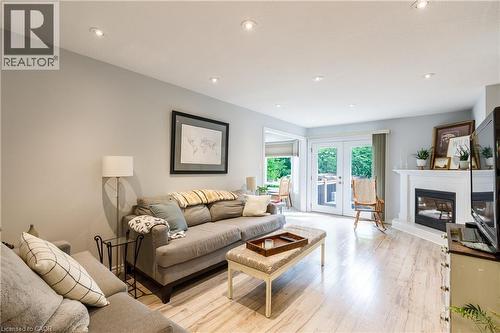 Bright living area featuring light wood-finish flooring and recessed lighting - 907 Doon Village Road, Kitchener, ON 