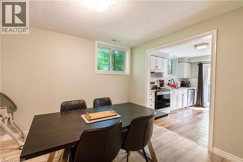 Dining area featuring light wood-finish flooring, a window, and recessed lighting - 907 Doon Village Road, Kitchener, ON - Indoor