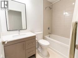 Bathroom featuring a single vanity with stone-finish countertop, undermount sink, and contemporary faucet - 