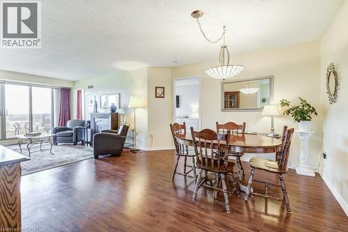 Open concept living and dining area featuring wood-finish flooring - 1201 North Shore Boulevard E Unit# 706, Burlington, ON - Indoor