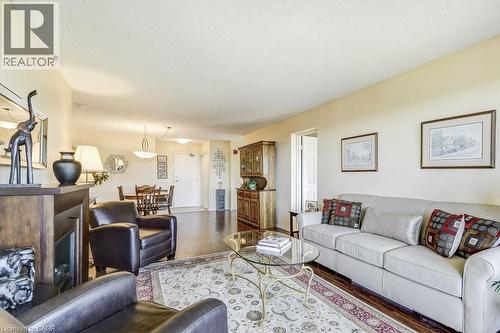 Open-concept living area with dark wood-finish flooring - 1201 North Shore Boulevard E Unit# 706, Burlington, ON - Indoor Photo Showing Living Room