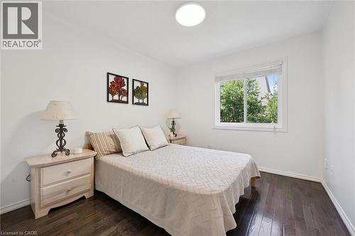 Hardwood-finish flooring complementing white walls and trim - 600 White Elm Boulevard Unit# 9, Waterloo, ON 