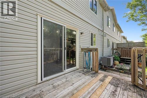 Exterior deck featuring wood planking and a sliding glass door with a screen - 600 White Elm Boulevard Unit# 9, Waterloo, ON 