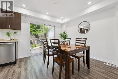 Dining area featuring wood-finish flooring, recessed lighting, and a sliding glass door providing access to an outdoor deck - 600 White Elm Boulevard Unit# 9, Waterloo, ON 