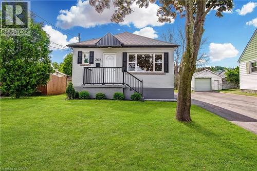 Single-story residence featuring a light-colored brick exterior and dark accent trim - 202 Erindale Avenue, Hamilton, ON 