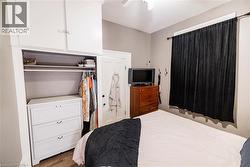 Built-in wardrobe system featuring upper cabinetry, an open hanging area, and lower drawers - 