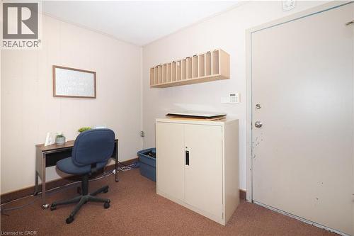 Neutral wall color, wood-finish wall paneling, and brown carpet flooring - 731 King Street E, Cambridge, ON 