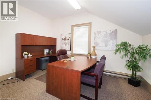 Carpeted room with sloped ceilings, white walls, and a single window with blinds - 731 King Street E, Cambridge, ON 