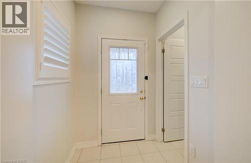 Doorway with tile patterned flooring and baseboards - 302 Jean Landing, Milton, ON 