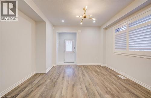 Entrance foyer with hanging lights and light wood finished floors - 302 Jean Landing, Milton, ON 