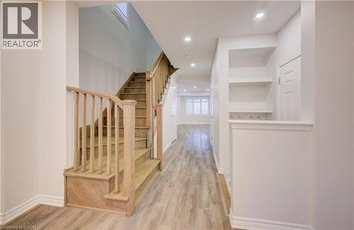 Hallway with light wood finished floors and recessed lighting - 302 Jean Landing, Milton, ON 