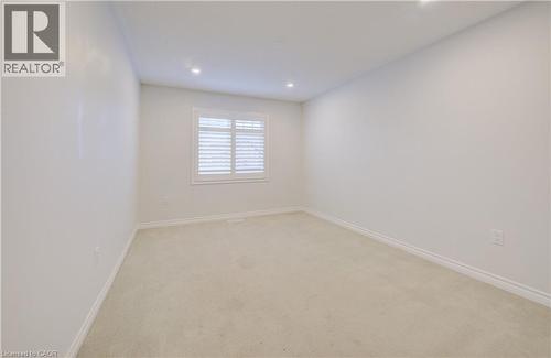 Unfurnished room with light carpet and recessed lighting - 302 Jean Landing, Milton, ON 