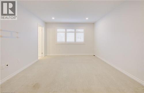 Spare room featuring light carpet and recessed lighting - 302 Jean Landing, Milton, ON 