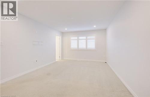Empty room with light carpet and recessed lighting - 302 Jean Landing, Milton, ON 