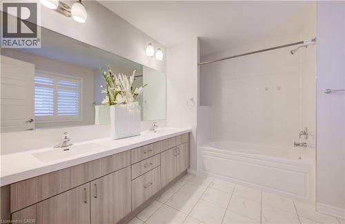 Bathroom with double vanity and tub / shower combination - 302 Jean Landing, Milton, ON 