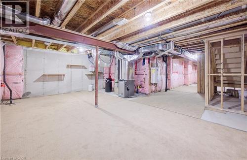 Unfinished below grade area featuring heating unit and water heater - 302 Jean Landing, Milton, ON 