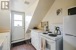 Third floor kitchen with outdoor access to deck. - 