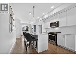 Spacious kitchen featuring a massive island, tons of counter space and storage, making it the perfect hub for entertaining and everyday living. - 