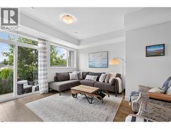 Bright and spacious living room with great natural light and direct access to the private patio, creating a seamless indoor-outdoor living experience. - 
