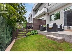 Private patio and yard space, perfect for BBQs, outdoor dining, entertaining guests, or letting kids and pets play. - 